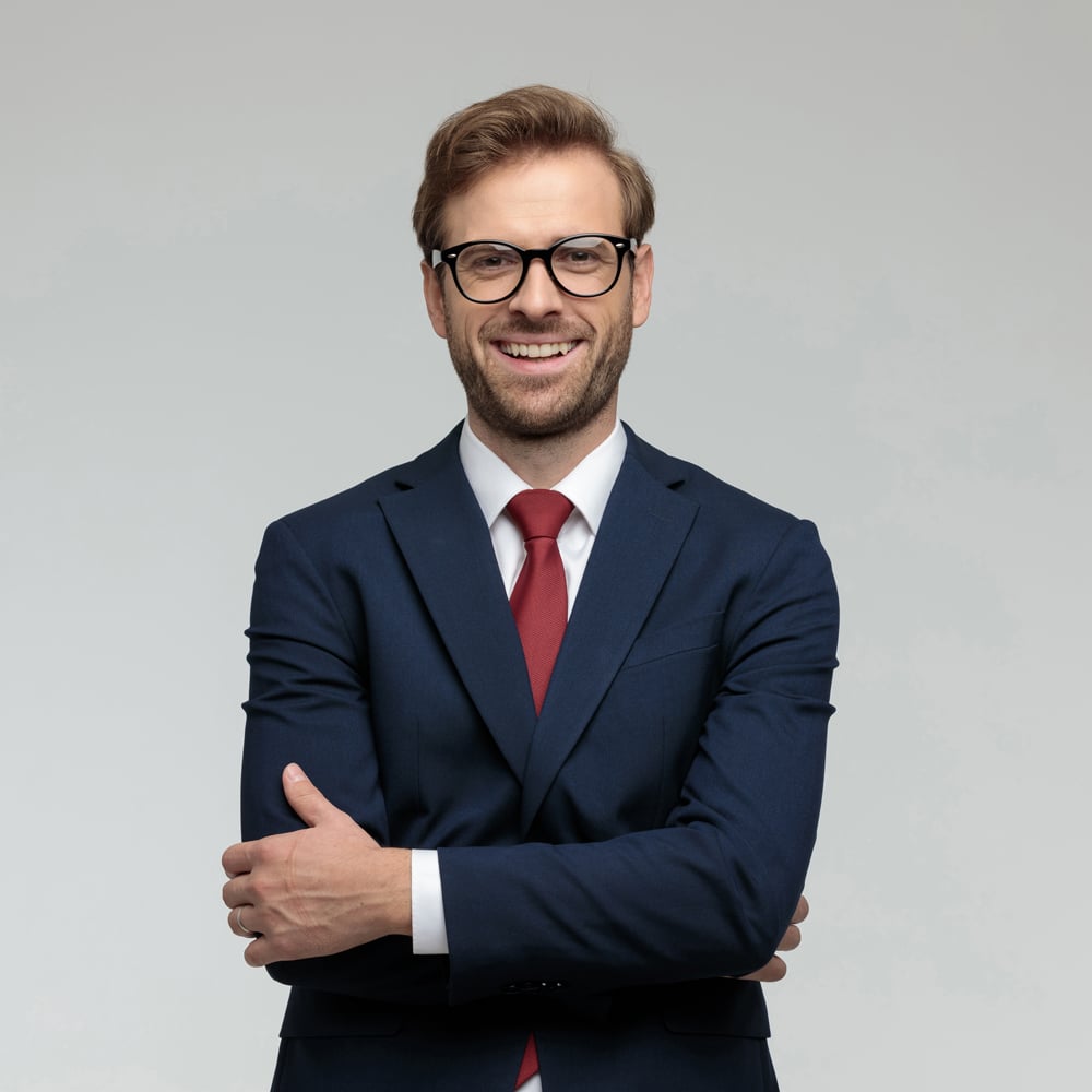 man dressed in blue suit with crossed arms