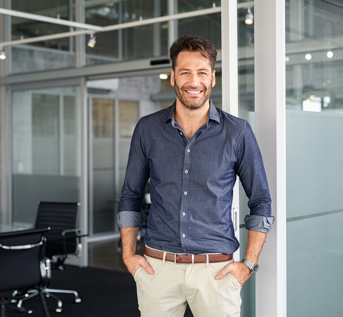 bearded man standing in front of modern empty office