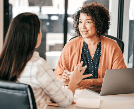 woman interviewing young woman for a job at a desk