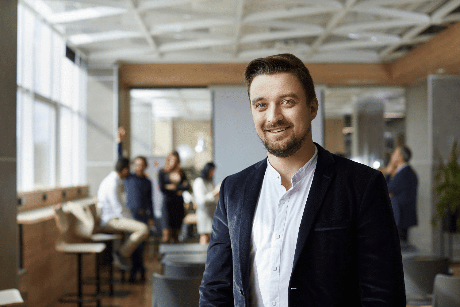 male business professional with employees in the background