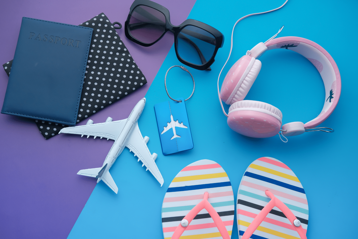 summer vacation travel items on purple and blue background