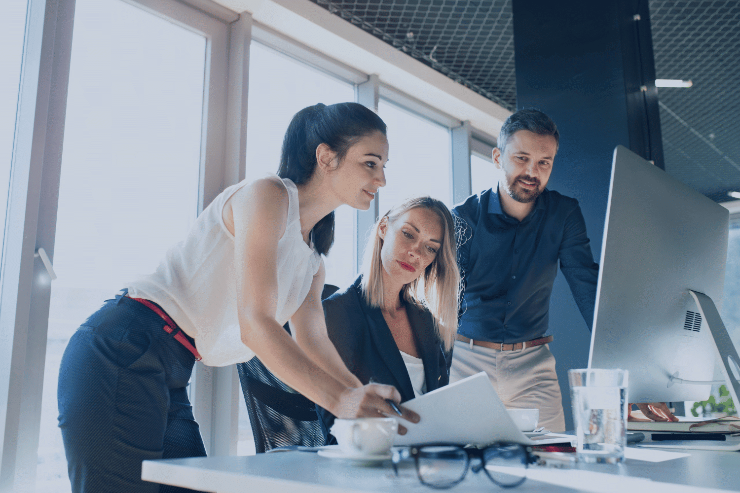 three gen z professionals working together in an office setting