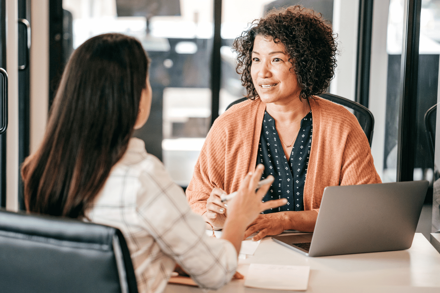 woman interviewing young woman for a job at a desk