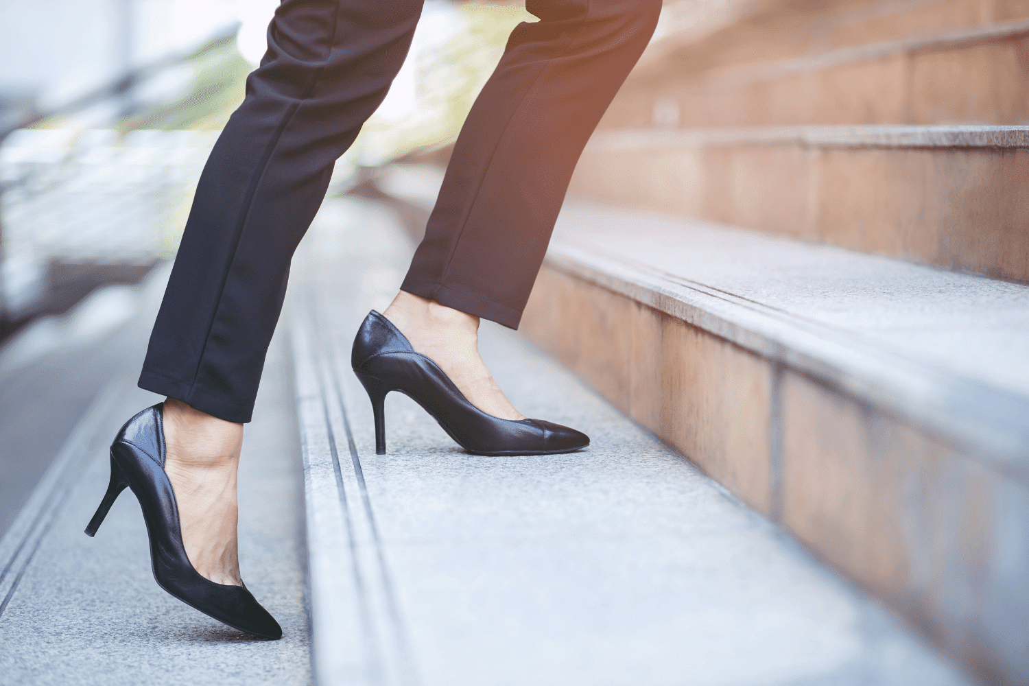 professional woman in high heels walking up steps