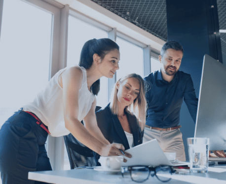 three gen z professionals working together in an office setting