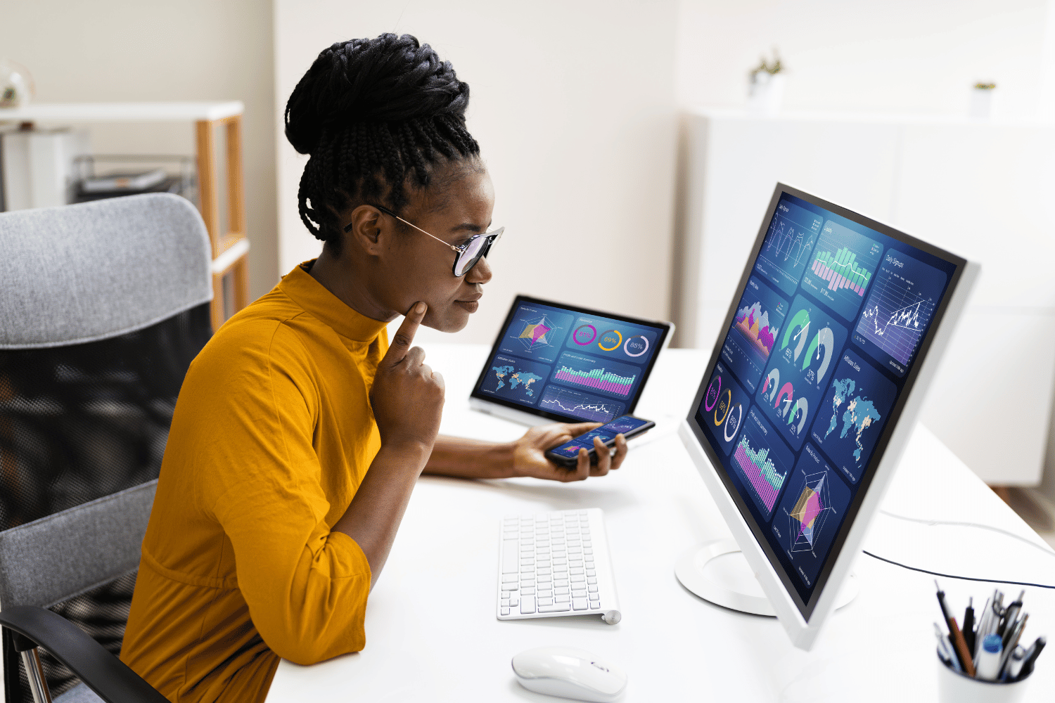 Young woman studying charts on a computer