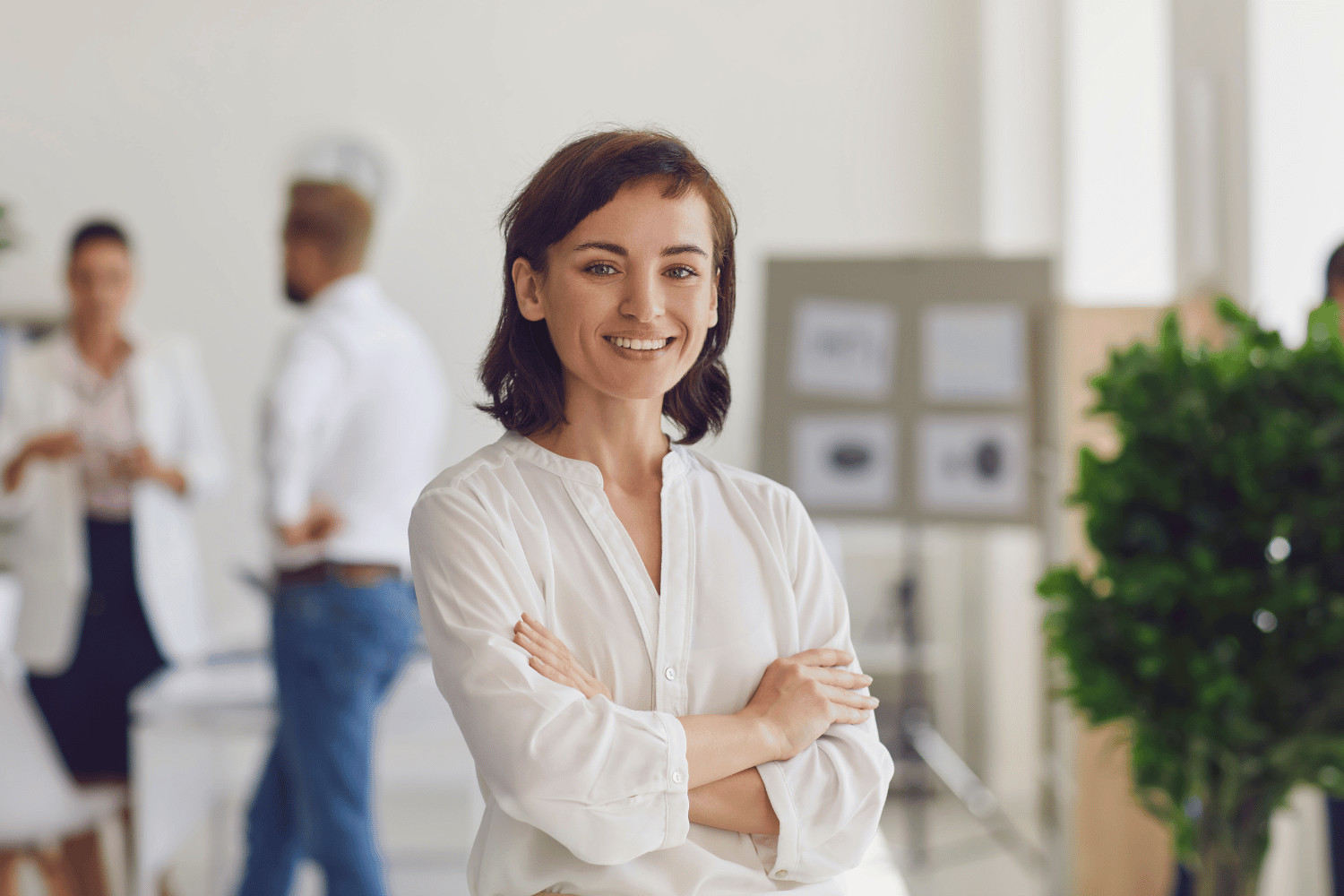 Confident business woman with arms crossed in office setting
