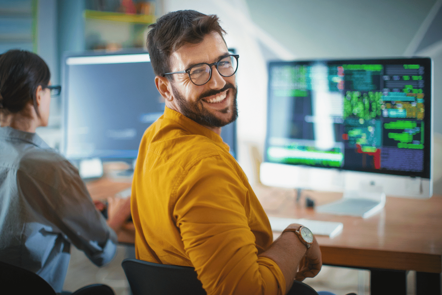 A software engineer working in a modern office, illustrating the professional technical talent that organizations can access when they partner with an agency to source top tech talent and navigate the complexities of high-demand hiring markets.