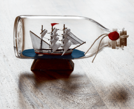 Tiny model sailing ship in a glass bottle