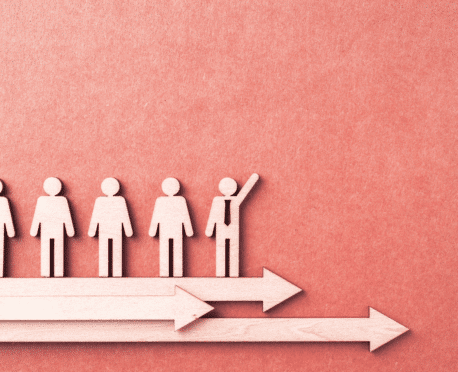 Conceptual image of a leadership pipeline development process featuring wooden cutouts on directional arrows. The highlighted figure symbolizes a high-potential leader identified by Oggi Talent's executive search partners for succession planning.