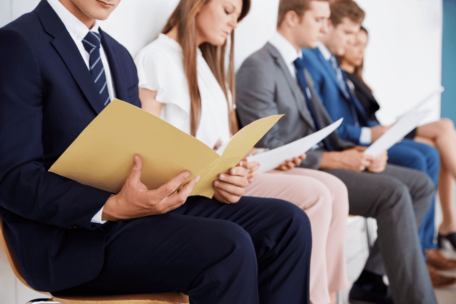 Business professionals seated in a hiring interview or assessment process, illustrating leadership bench strength and executive succession planning.