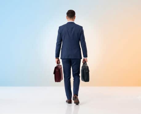 Business leader carrying two briefcases representing a fractional AI finance executive and dual-hat leadership