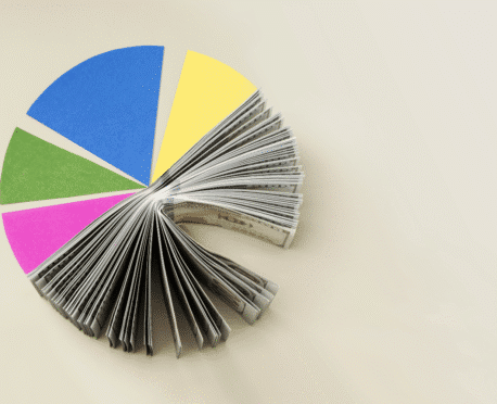 Colorful pie chart made from financial documents symbolizing tech-fluent CFO recruiting and finance leadership