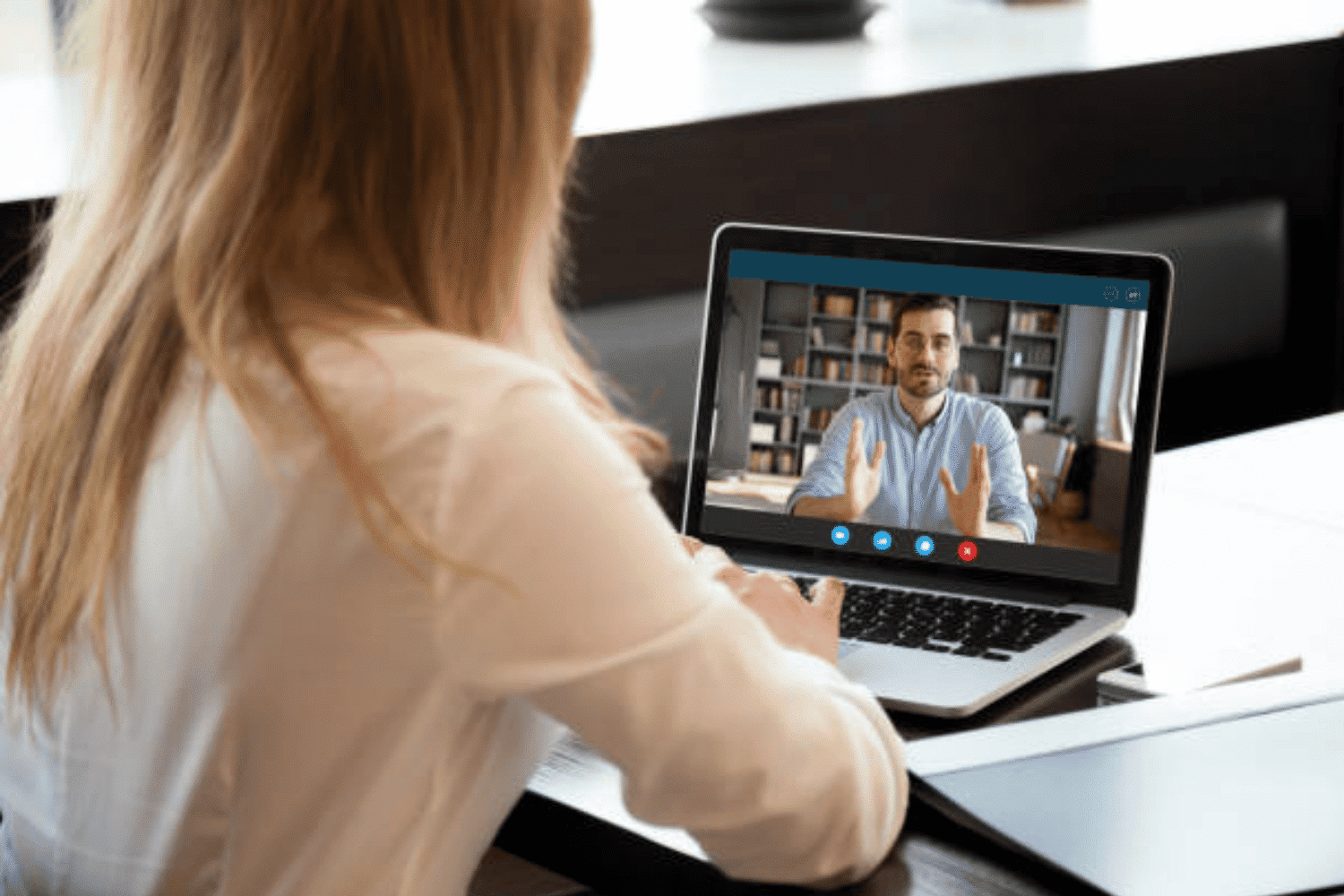 Professional candidate participates in a virtual job interview on a laptop, demonstrating interview etiquette and professional presentation.